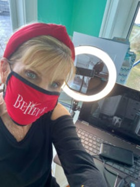 A person wearing a red hat and a face maskDescription automatically generated